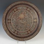 A late 19th/ early 20th century Syrian copper and white metal inlaid circular tray, decorated with