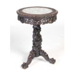 A Chinese dark wood and porcelain mounted occasional table, Qing Dynasty, the circular top enclosing