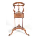 A George III style mahogany wig/ washstand , fitted with two small drawers, raised on three
