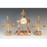 A late 19th/ early 20th century gilt metal mounted marble clock garniture, the clock with circular