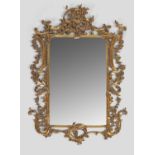 A large George III style giltwood wall mirror, the rectangular bevelled mirror plate within a