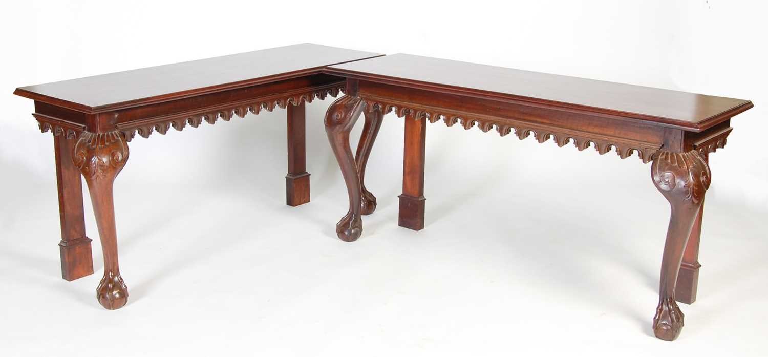 A pair of George III style mahogany console tables, the rectangular tops above a plain frieze with