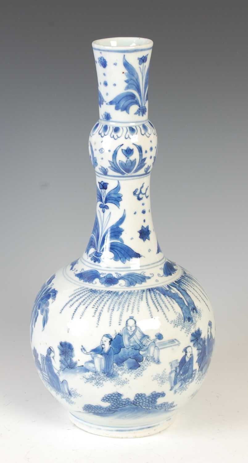 A Chinese porcelain blue and white bottle vase, Qing Dynasty, decorated with scholars and other