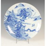 A Chinese blue and white porcelain charger, 20th century, decorated with pavilions and pine trees in