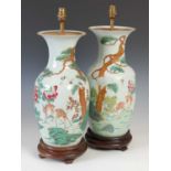 A pair of Chinese porcelain famille rose vases, mounted as table lamps, late 19th/ early 20th