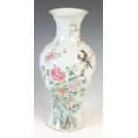 A Chinese porcelain famille rose vase, Qing Dynasty, decorated with rock work, peony and pair of