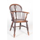 A 19th century ash and elm Windsor chair, on four turned supports united by an H-shaped stretcher