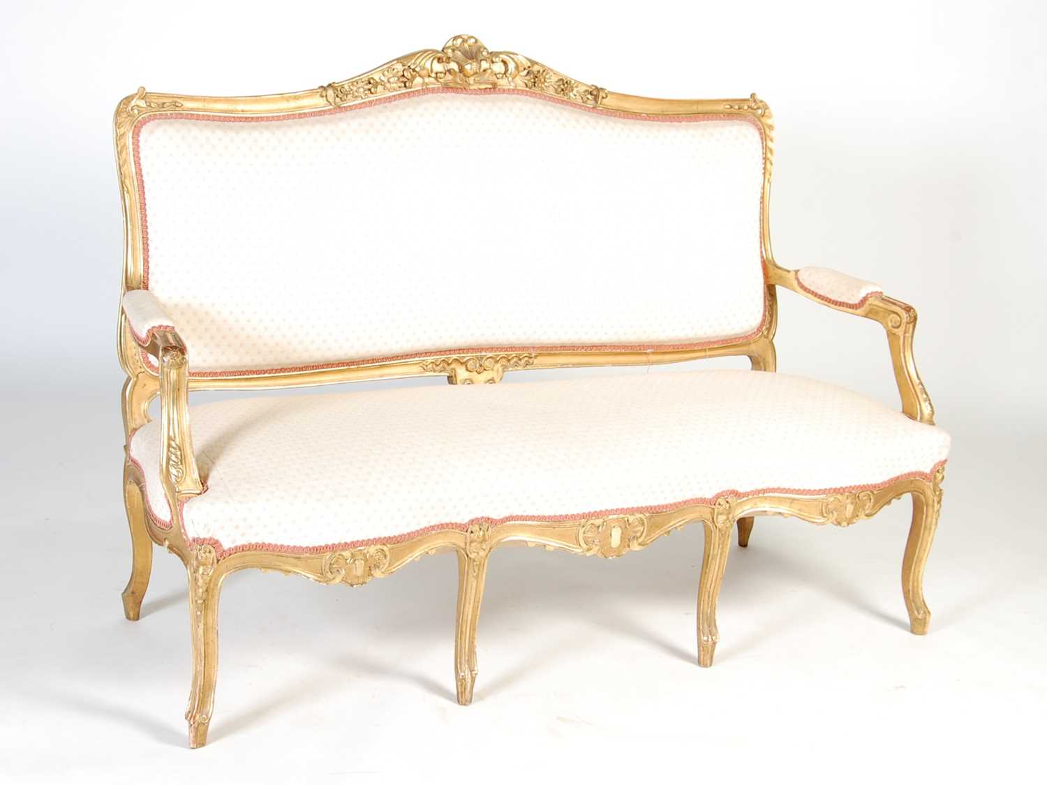 A late 19th / early 20th century giltwood three seat sofa, the rectangular upholstered back, arms
