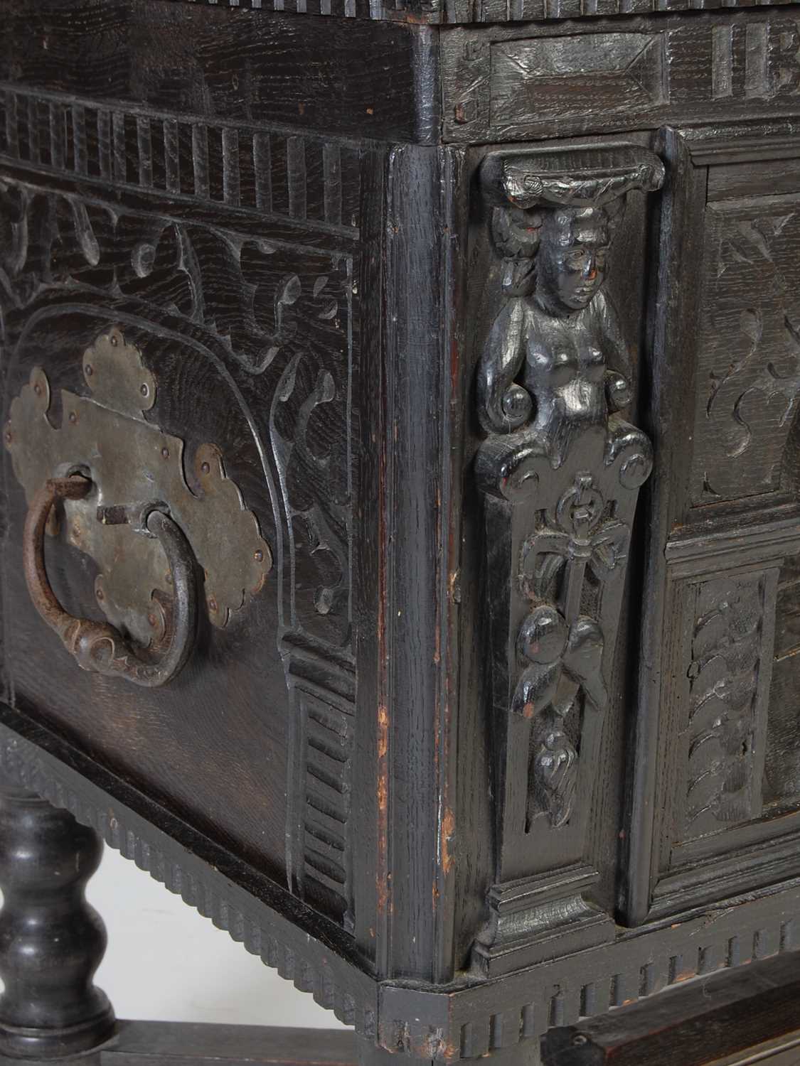 An antique stained oak coffer on integral stand, the hinged cover with two incised figural carved - Image 5 of 13