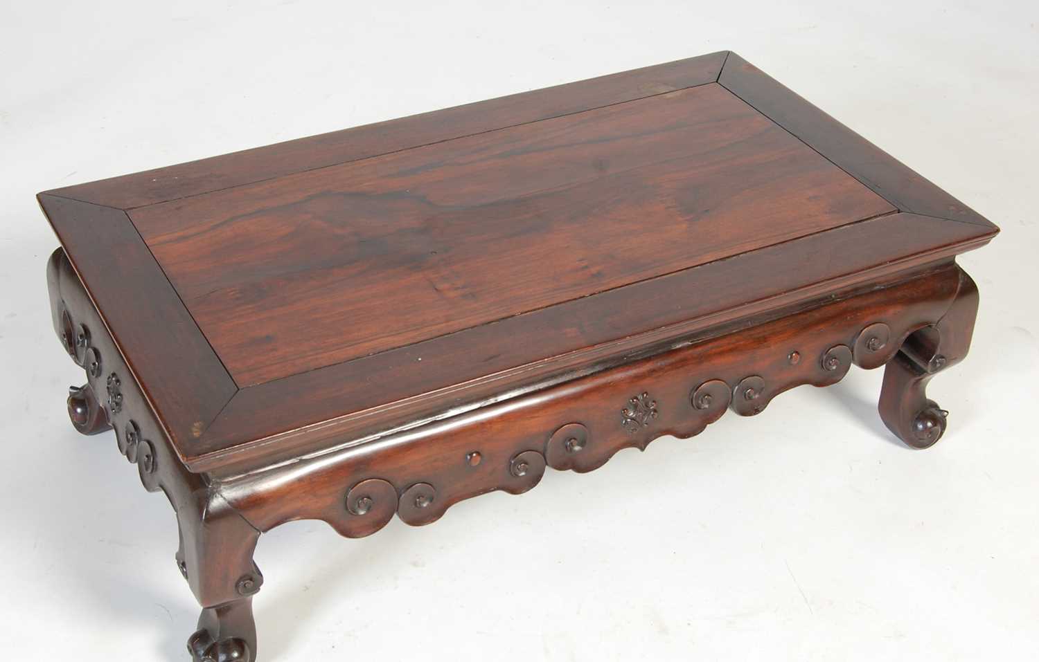 A Chinese dark wood kang table, late 19th/ early 20th century, the panelled rectangular top above - Image 3 of 5