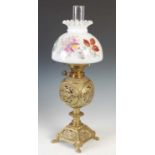 A late 19th/ early 20th century brass oil lamp, the opaque white glass shade with floral painted