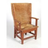 A late 19th century/ early 20th century childs Orkney chair, with woven back and drop-in strung seat