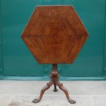 A George III style mahogany snap top occasional table, the hinged cross banded hexagonal top resting