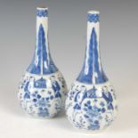 A pair of Chinese porcelain blue and white bottle vases and one cover, Qing Dynasty, decorated