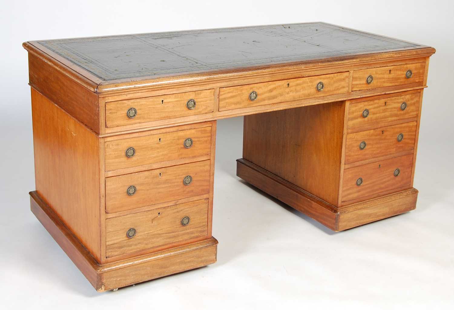 A 19th century mahogany pedestal desk, the rounded rectangular top with green and gilt leather