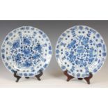 A pair of Chinese porcelain blue and white lotus form plates, Qing Dynasty, bearing six character