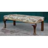 A 20th century mahogany rectangular shaped stool, with foliate upholstered seat raised on two