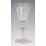 An 18th century Continental wine glass, the tapered cylindrical bowl with engraved armorial crest