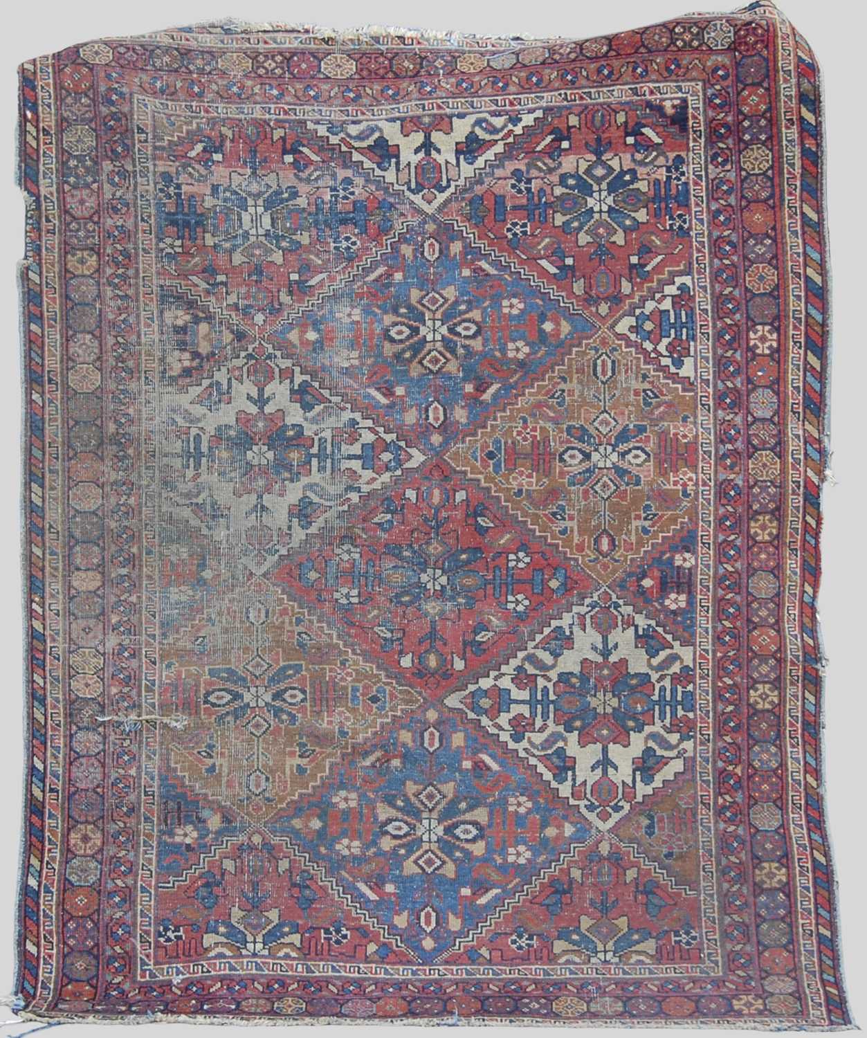 A Persian rug, late 19th/ early 20th century, the rectangular field decorated with lozenge shaped