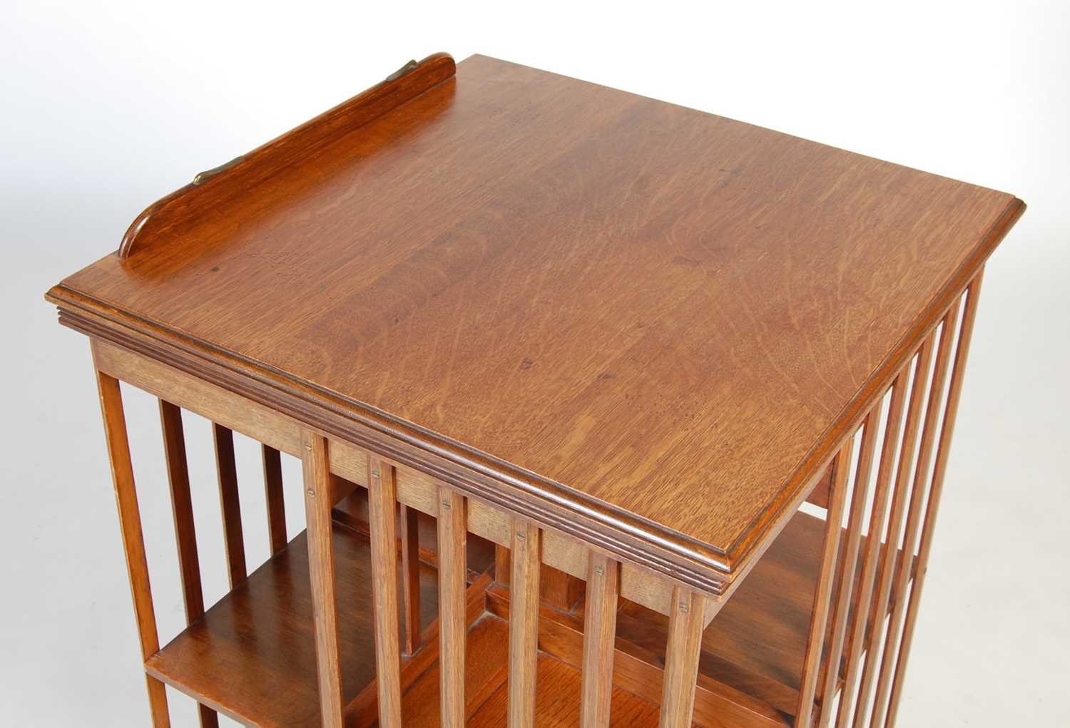 A late 19th/ early 20th century oak revolving bookcase, the square hinged top opening to a book rest - Image 2 of 7