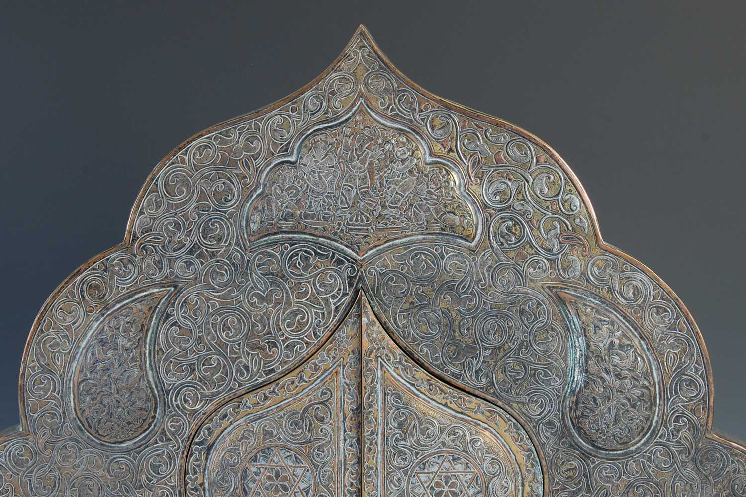 A 19th century Persian brass, copper and white metal inlaid mihrab shaped wall mirror, with a pair - Image 2 of 5