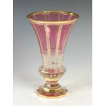 A Bohemian clear and ruby glass vase, 20th century, of tapered cylindrical form on a decagon-