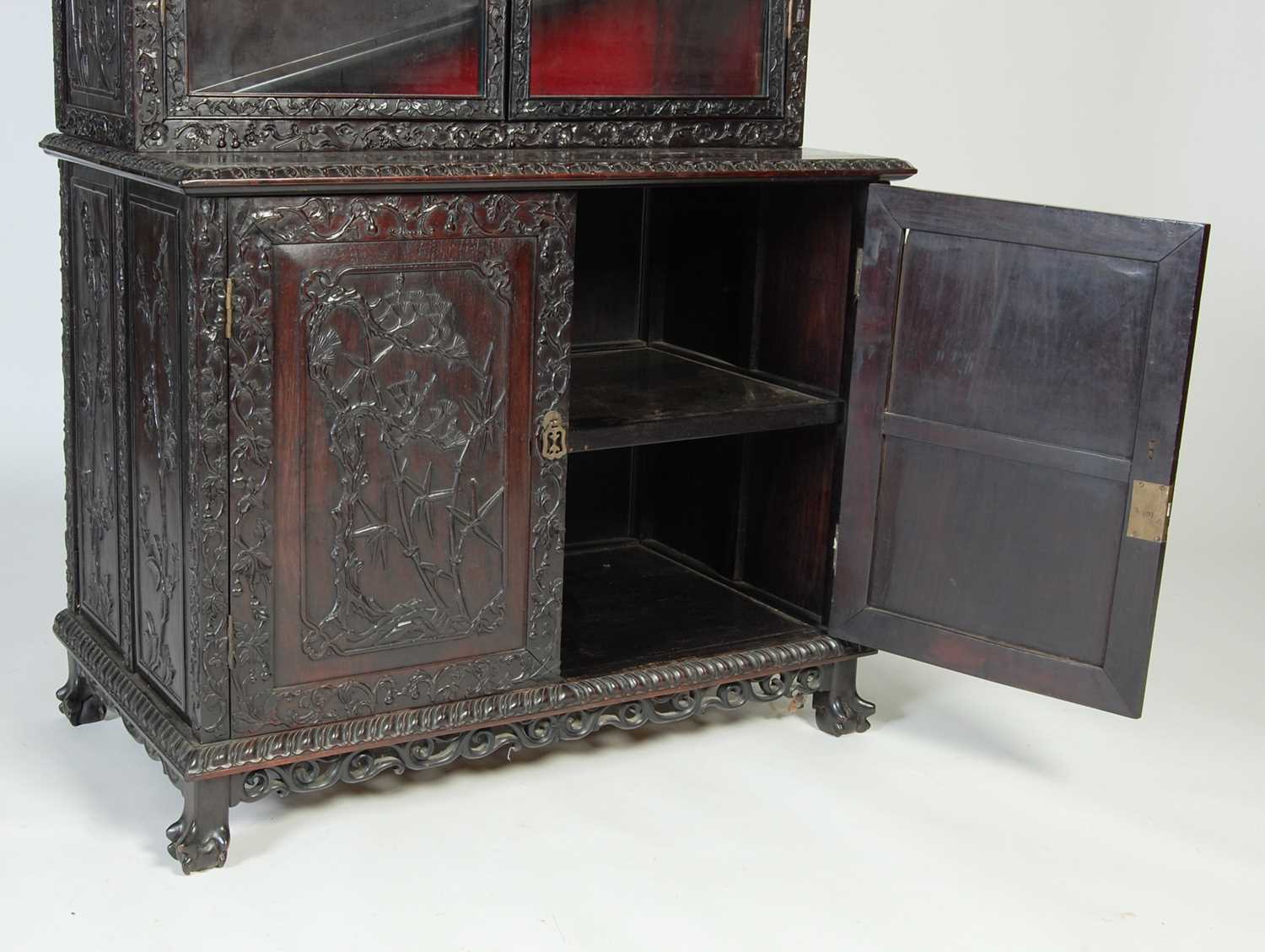 A Chinese dark wood display cabinet/ bookcase, late 19th/ early 20th century, the upper section with - Image 7 of 8