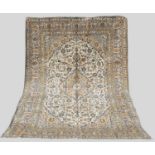 A Persian Kashan carpet, the off-white rectangular ground decorated with stylised flowers and