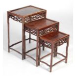 A nest of three Chinese dark wood occasional tables, late 19th/ early 20th century, the