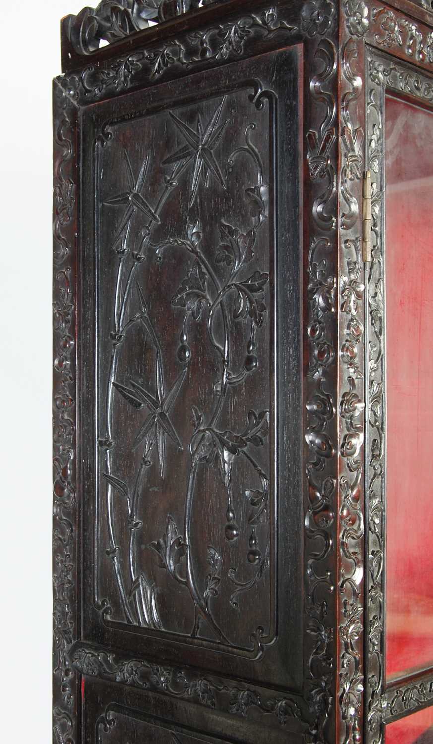 A Chinese dark wood display cabinet/ bookcase, late 19th/ early 20th century, the upper section with - Image 5 of 8