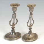 A pair of early 20th century silver plated lyre form candlesticks, with detachable drip pans, 21cm