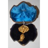 A Victorian yellow metal brooch with oval tasselled suspension, gross weight 11.4 grams.