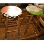 A pair of painted barstools, one with goose in jug, the other a chicken