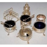 A collection of silver to include five bar toast rack, three-piece cruet set, pair of salt cruets,