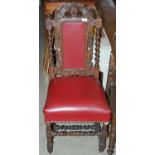 A late Victorian carved oak Jacobean style hall chair with red leatherette upholstered back and seat