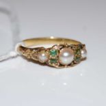 A yellow metal, split pearl and green stone ring, gross weight 2 grams, ring size 'N'.