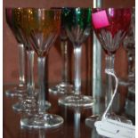 A set of six Baccarat liqueur glasses, each with an individually coloured top.