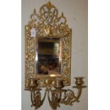A brass girandole wall mirror, set with rectangular bevelled glass plate bordered by pierced foliate