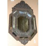 A late 19th / early 20th century copper mounted cushion framed wall mirror, with shell scroll