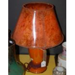 An early 20th century Art Deco orange glass table lamp and mottled orange hand tied celluloid shade