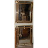 A pair of rectangular gold coloured cushion wall mirrors with bevelled mirror plates.