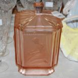 An Art Deco peach glass tapered square dressing table jar and cover, moulded with four panels of