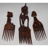 Tribal Art: three vintage figural carved wood afro combs.