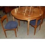 A mid-century teak dining room suite comprising sideboard with a pair of central doors flanked by