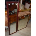 A stained wood bevelled glass wall mirror together with a long rectangular wall mirror