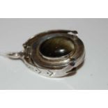 Ari D. Norman, a silver and cabochon set pendant locket, Continental import marks 1977, opening to
