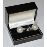 A pair of Art Deco style white metal, pearl and diamond set earrings.