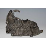 An early 20th century spelter inkwell in the form of a goat with hinged saddle opening to reveal a