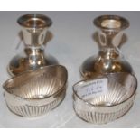 A pair of Birmingham silver candle stands and a pair of Birmingham silver oval-shaped salts with