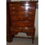 A 20th century walnut chest on stand, the upper section with four long graduated drawers, the